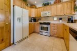 Kitchen with full-size refrigerator, oven, microwave, dishwasher and small appliances